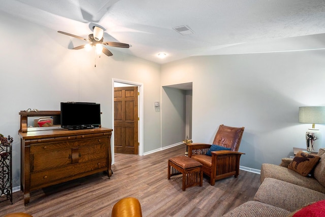 living room with hardwood / wood-style flooring and ceiling fan