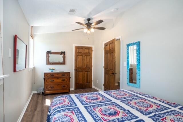 bedroom featuring dark wood-type flooring, ceiling fan, and vaulted ceiling