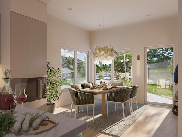 dining area featuring light hardwood / wood-style floors and a notable chandelier