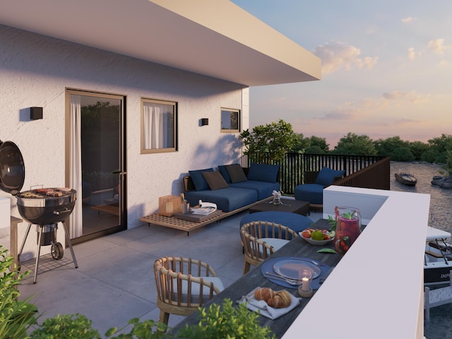 patio terrace at dusk featuring an outdoor living space