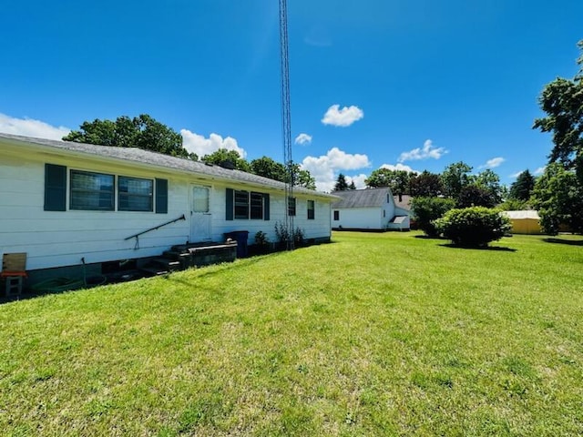 rear view of property with a lawn