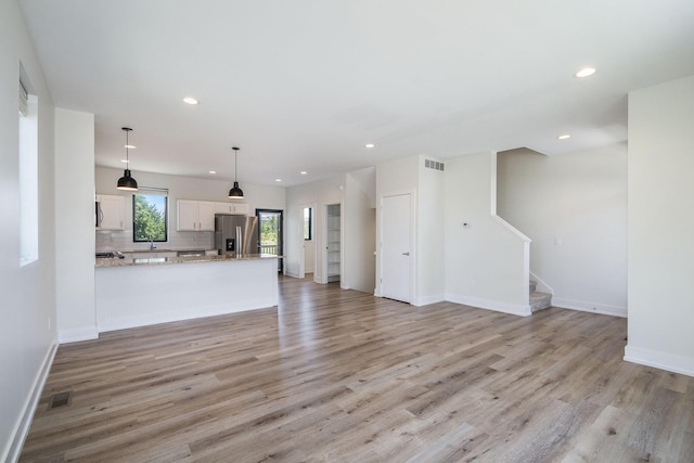 unfurnished living room featuring light wood-type flooring