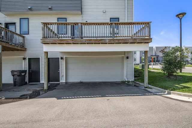 exterior space featuring a garage and a balcony