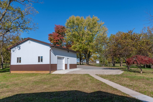 view of side of home with a yard