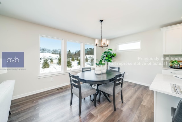 dining room with a notable chandelier and hardwood / wood-style flooring