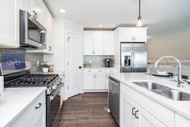 kitchen featuring sink, stainless steel appliances, white cabinets, and light stone countertops