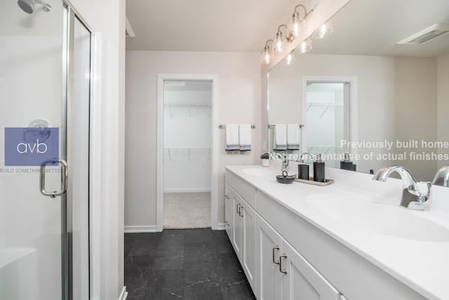 bathroom featuring an enclosed shower and vanity