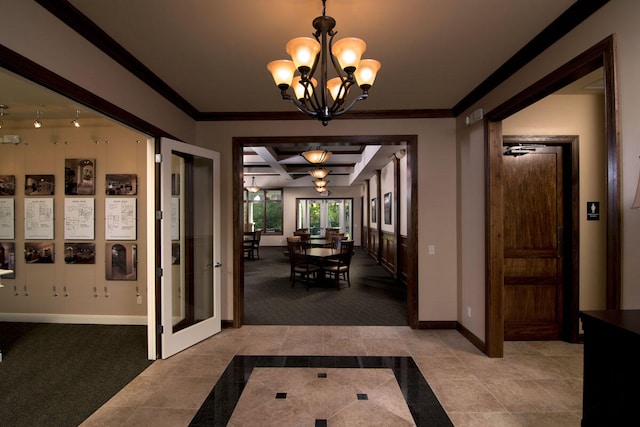 hall with coffered ceiling, french doors, beam ceiling, ornamental molding, and an inviting chandelier