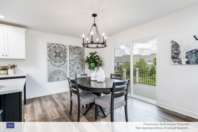 dining room featuring an inviting chandelier and dark hardwood / wood-style floors