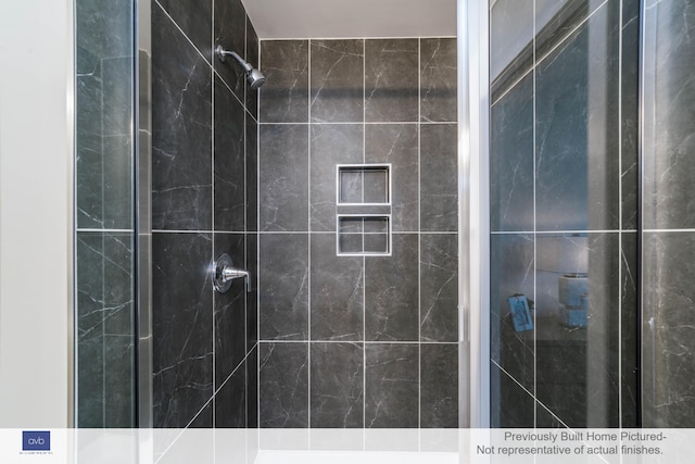 bathroom featuring tiled shower