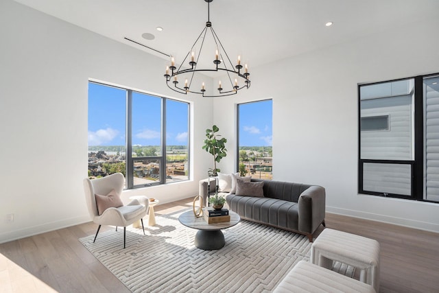 living room featuring a notable chandelier and light hardwood / wood-style floors