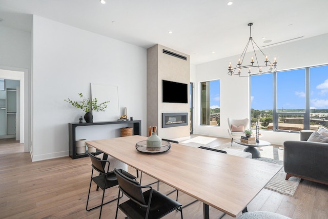 dining room featuring light hardwood / wood-style flooring and a notable chandelier