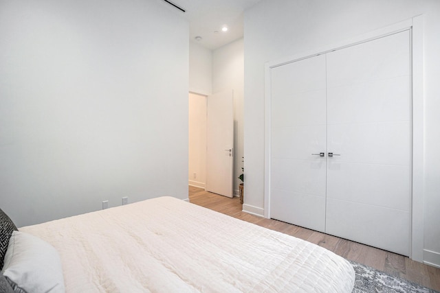 bedroom with a closet and light hardwood / wood-style flooring