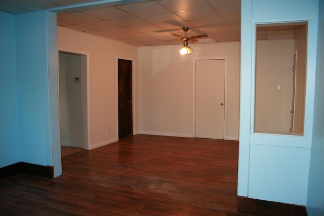 spare room with dark wood-type flooring and ceiling fan