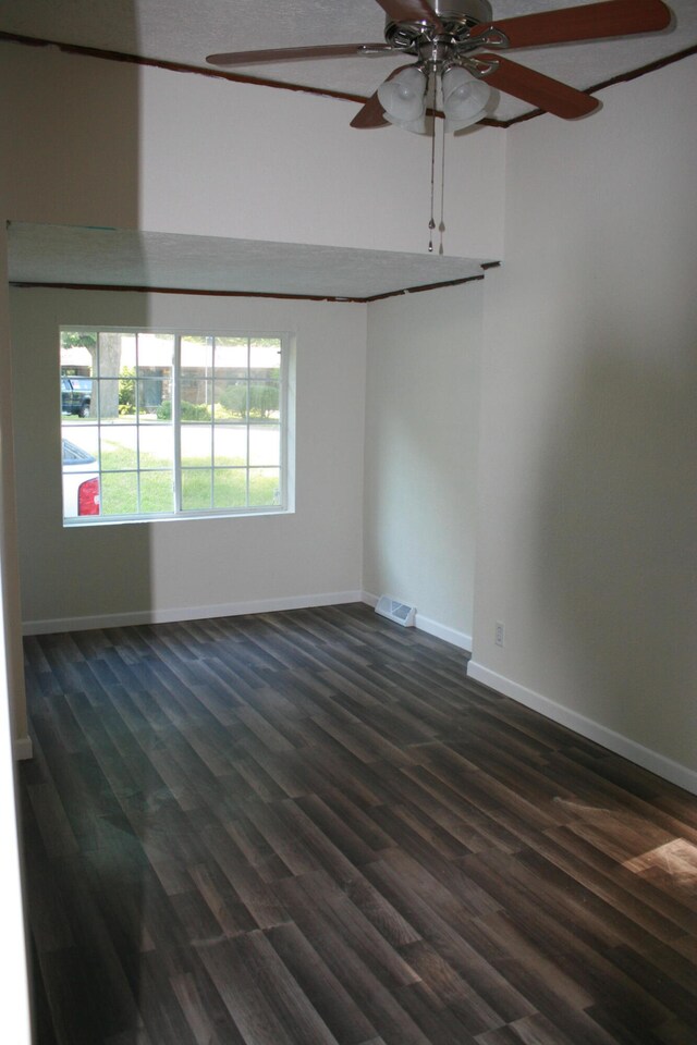 unfurnished room featuring ceiling fan and dark hardwood / wood-style flooring