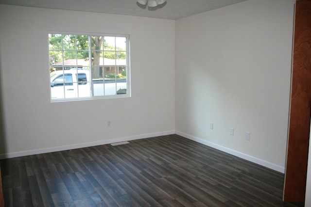 spare room with dark hardwood / wood-style flooring