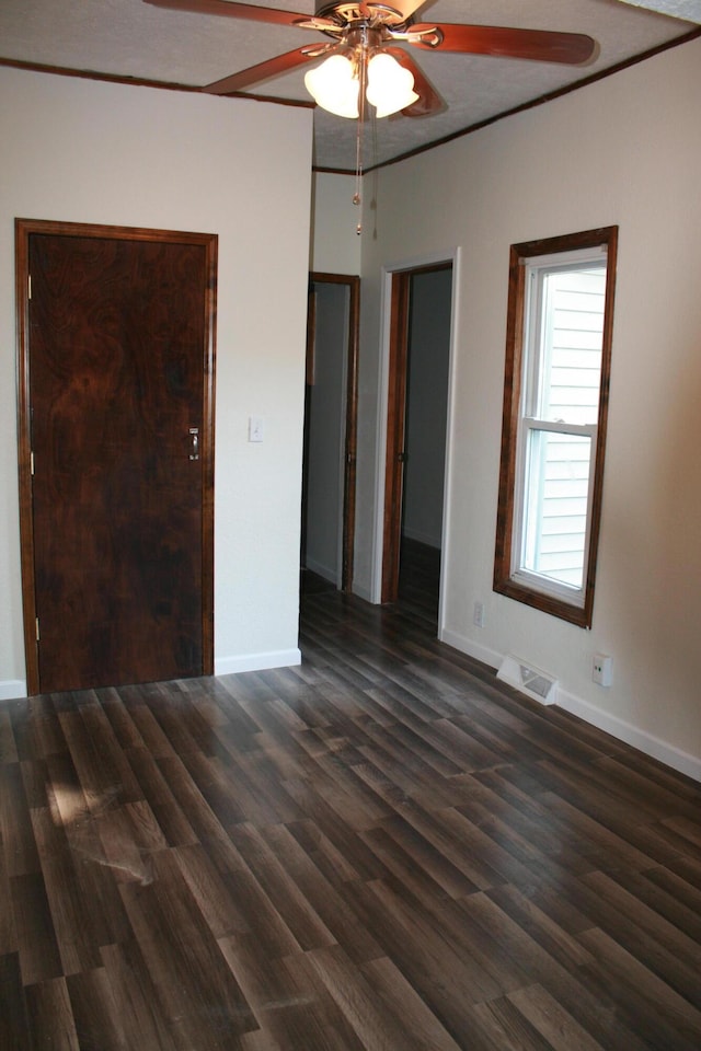 unfurnished bedroom with ceiling fan and dark hardwood / wood-style flooring