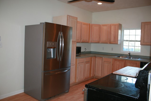 kitchen featuring stainless steel appliances, ceiling fan, sink, and light wood-type flooring