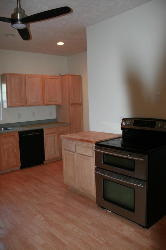 kitchen featuring double oven range, black dishwasher, light hardwood / wood-style flooring, and light brown cabinets