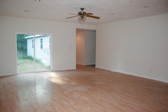 spare room featuring ceiling fan and light hardwood / wood-style flooring