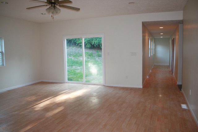 spare room with ceiling fan and light hardwood / wood-style flooring