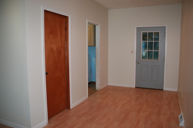 hallway with light hardwood / wood-style flooring