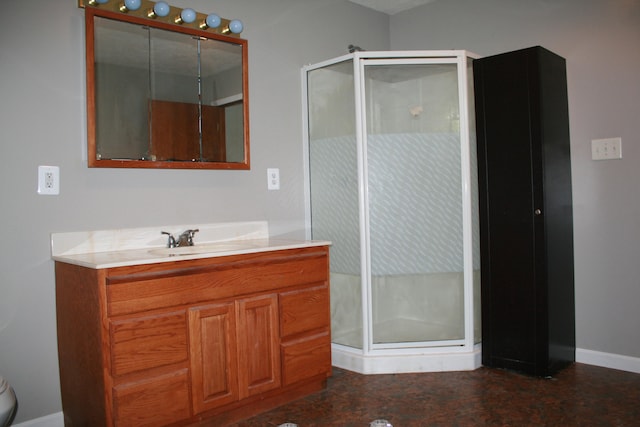 bathroom with a shower with door and vanity