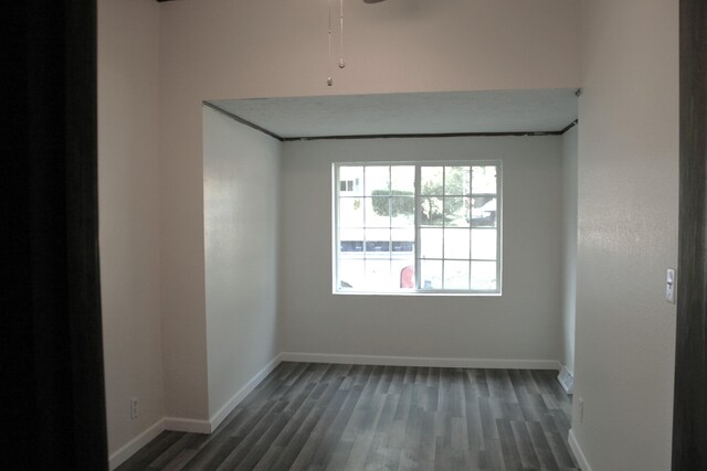 unfurnished room with dark hardwood / wood-style flooring