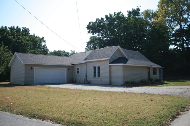 ranch-style house with a garage and a front yard