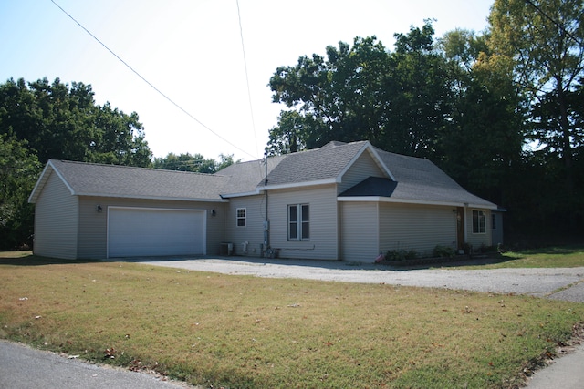 ranch-style house with a garage and a front yard