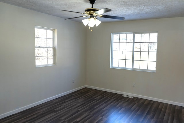 empty room featuring dark wood-type flooring, ceiling fan, and a textured ceiling