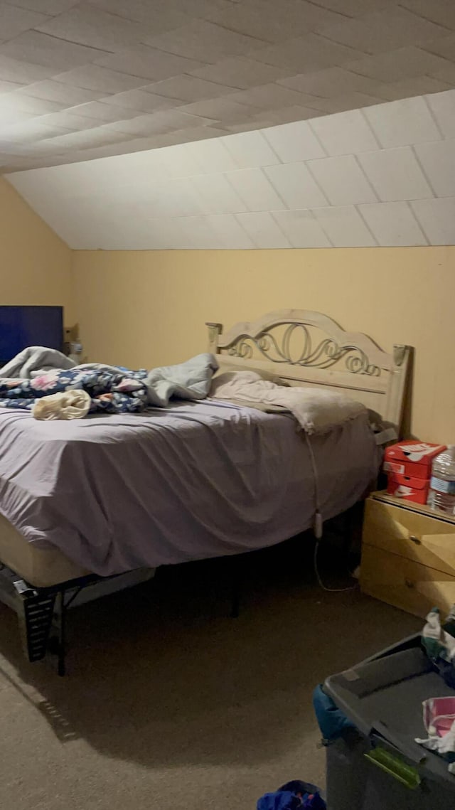 carpeted bedroom with vaulted ceiling