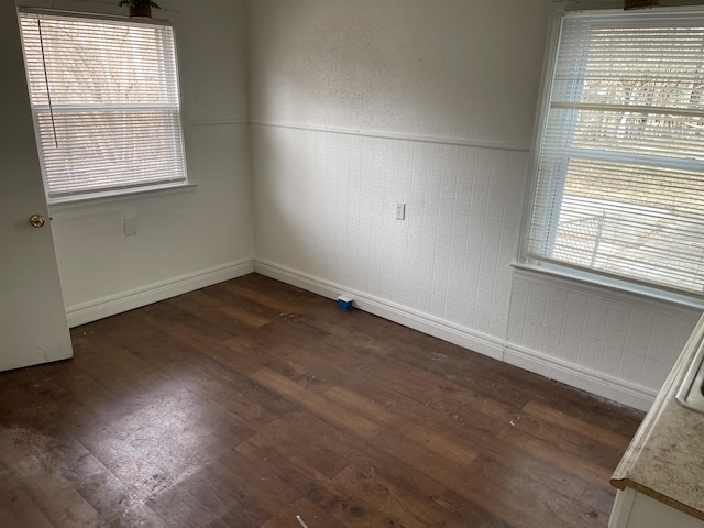 empty room with dark hardwood / wood-style floors