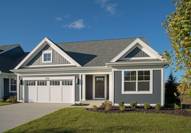 view of front facade featuring a garage and a front lawn