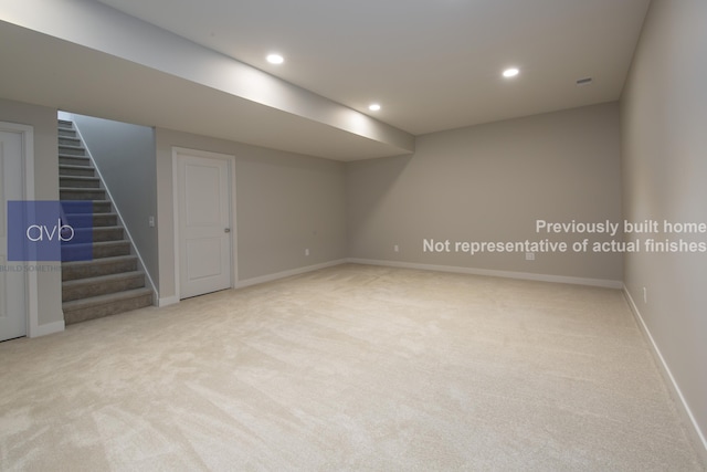 basement featuring light colored carpet