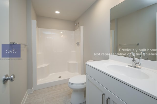 bathroom with vanity, toilet, and walk in shower