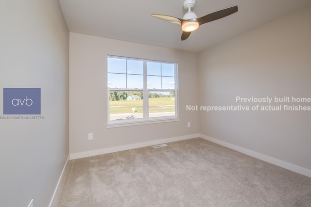 empty room featuring light carpet and ceiling fan