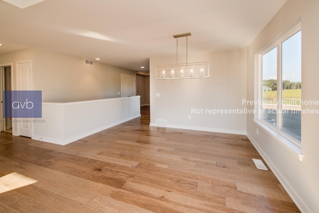 empty room with hardwood / wood-style floors