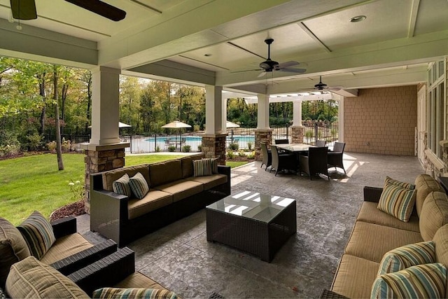 view of patio with an outdoor living space, a pool, and ceiling fan