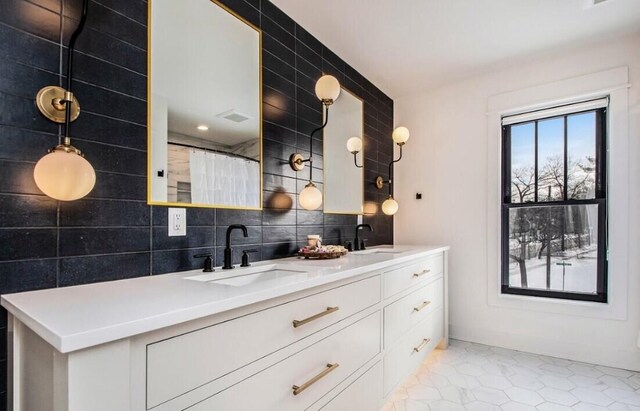 kitchen featuring white cabinetry, sink, decorative light fixtures, and light tile patterned flooring