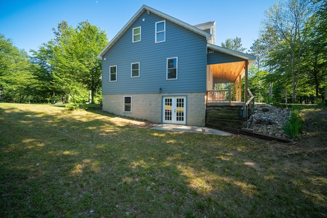 rear view of house with a yard and french doors