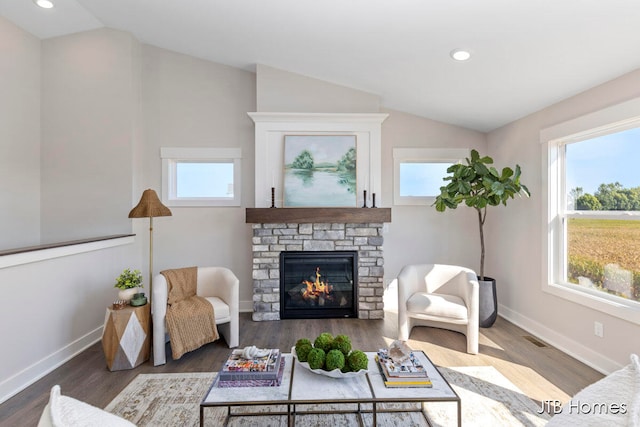 living room featuring a fireplace, plenty of natural light, dark hardwood / wood-style floors, and lofted ceiling