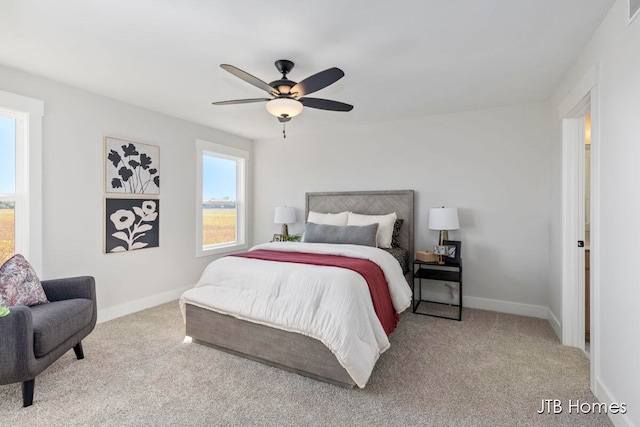 bedroom with ceiling fan and light colored carpet