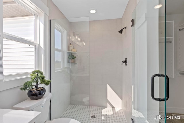 bathroom featuring an enclosed shower and toilet