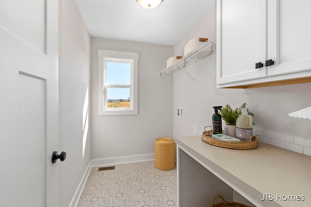 laundry area featuring hookup for a washing machine and cabinets