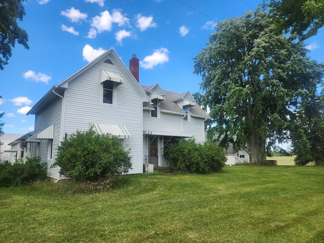 rear view of house with a yard