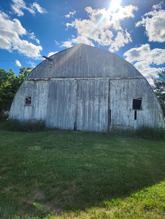 view of outbuilding with a lawn