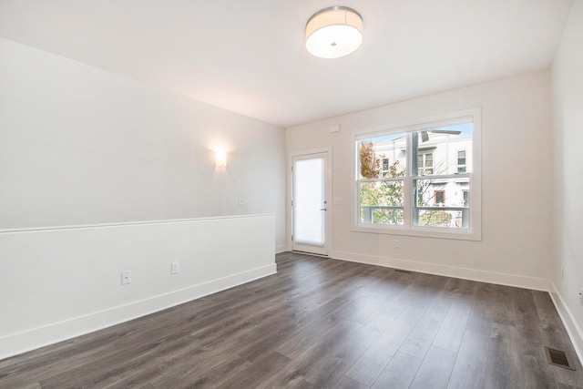 unfurnished room with dark hardwood / wood-style floors