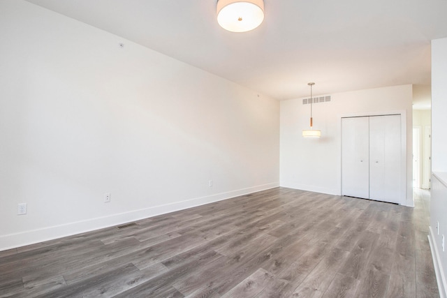 spare room featuring dark hardwood / wood-style flooring