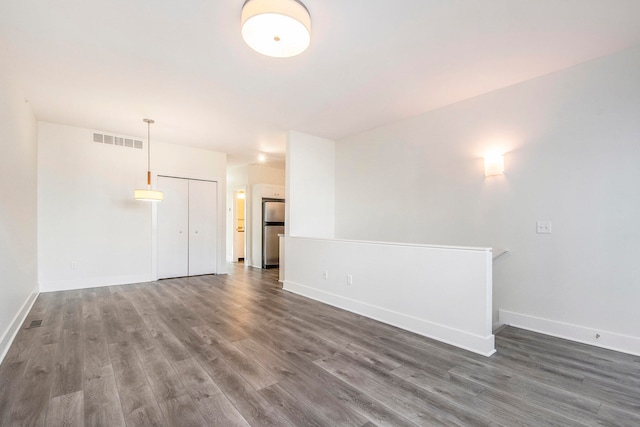 spare room featuring dark hardwood / wood-style flooring